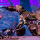 A group of smaller mechs assault a massive, rusted robot.